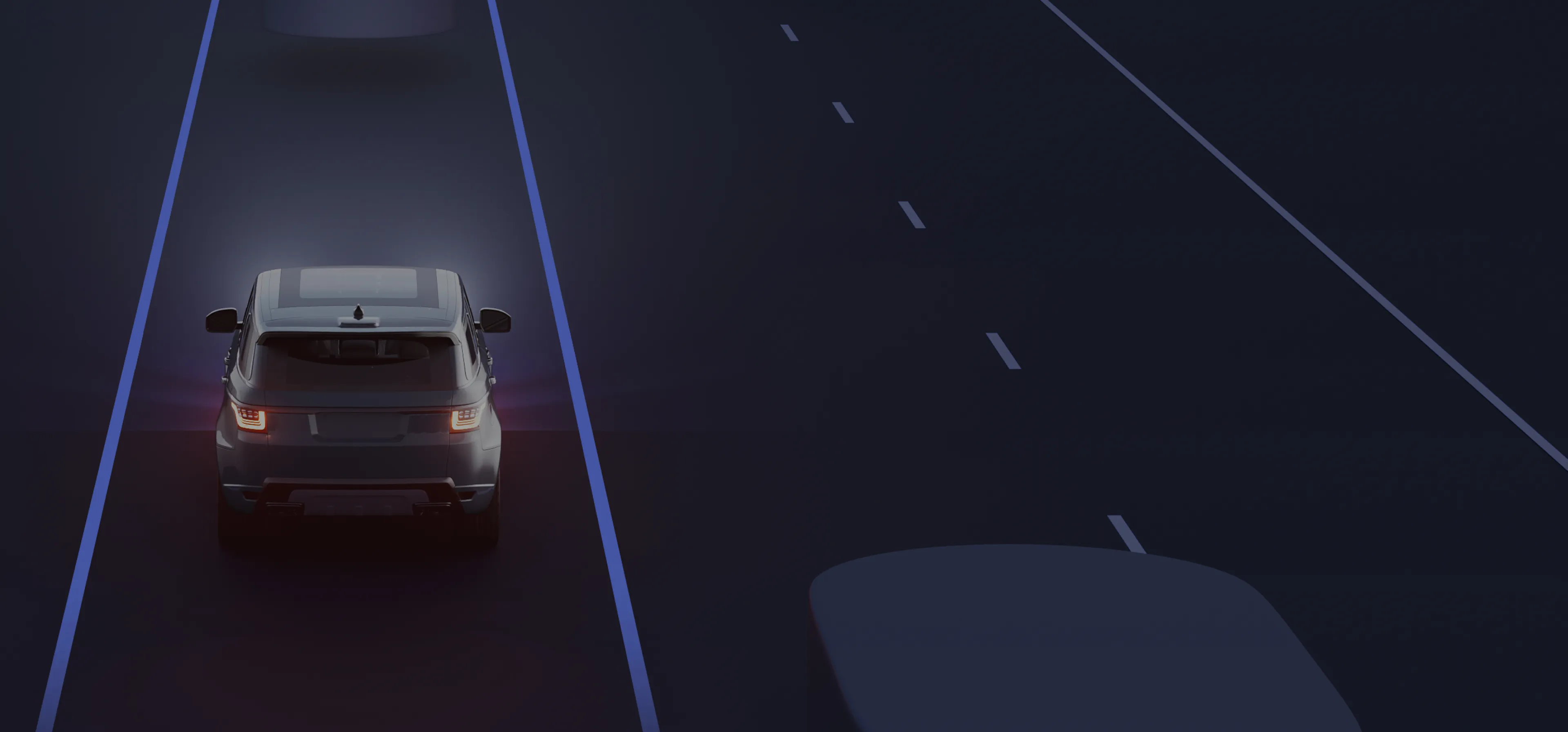A car driving at night between glowing lane markers